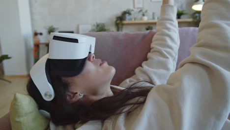 Woman-Playing-in-Virtual-Space-with-VR-Headset-at-Home
